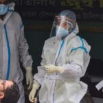 A health worker in PPE kit collects a swab sample from a man for coronavirus testing, at Sarojini Nagar in New Delhi on August 18.