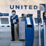 United Airlines employees work a ticketing area at Terminal 1 at O'Hare International Airport in July. The airline is adding some routes, including flights between Chicago and New Delhi, India, and Kona, Hawaii.