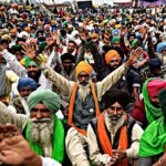 A group of protesting farmers march towards the residence of ruling Bhartiya Janata Party leader Mahesh Sharma to hand over a list of their demands during a protest against new farm in Noida on the outskirts of New Delhi, India, Saturday, Dec. 12, 2020. Indian farmers filed a petition with the Supreme Court on Friday seeking the quashing of three new laws on agricultural reform which they say will drive down crop prices, as they continued their two-week blockade of highways connecting to the Indian capital.