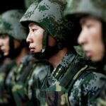 People's Liberation Army (PLA) soldiers shout as they practise with knives during a training session on snow-covered ground at a military base in Heihe, Heilongjiang province.