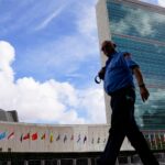 A member of the FDNY passes outside the United Nations headquarters, Tuesday, Sept. 21, 2021, during the 76th Session of the U.N. General Assembly in New York.