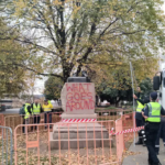 Vandalized statue of William Crowther in Hobart, with only severed bronze feet remaining and graffiti at the base.