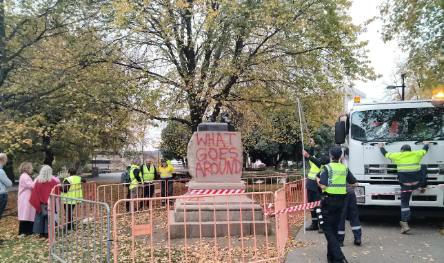 Vandalized statue of William Crowther in Hobart, with only severed bronze feet remaining and graffiti at the base.