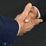 Kamala Harris and Donald Trump shake hands on stage before the 2024 presidential debate, showing a rare moment of civility.