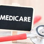 Workers spread cleaned construction sand on a road during a government dust-control initiative in Delhi to reduce PM10 pollution.