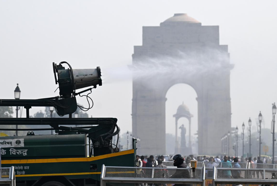 Water being sprayed on Kartavya Path in New Delhi to control air pollution on a smoggy day, November 17, 2025
