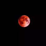 Blood Moon during total lunar eclipse on March 3, 2026, glowing red-orange in the night sky